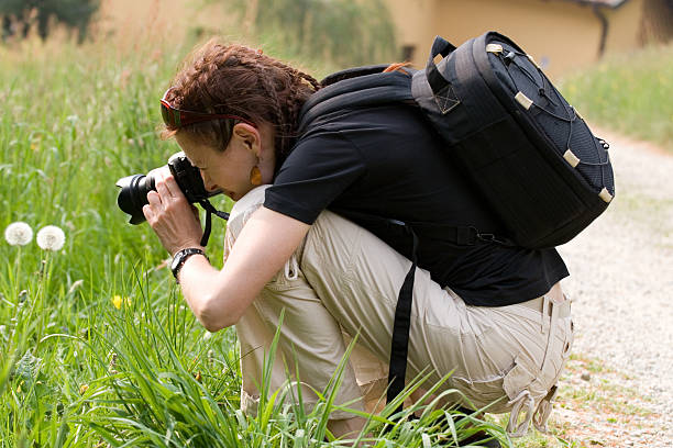 istock Young woman with digital camera 144294360