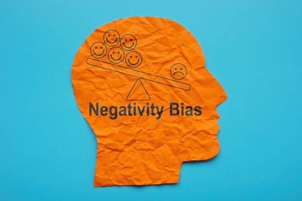 istock Head from paper and inscription Negativity bias. 1442945486
