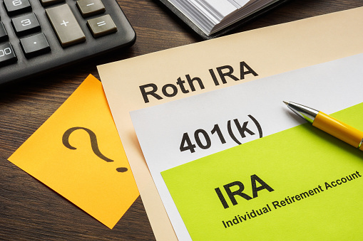 Documents with Retirement plans IRA, 401k and Roth IRA for choosing.