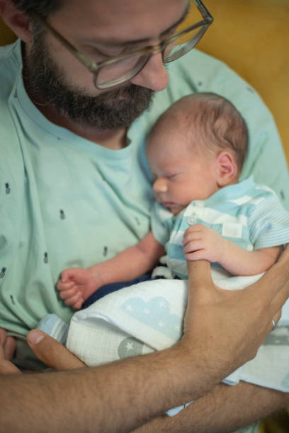 istock Dad putting newborn to sleep 1442945670
