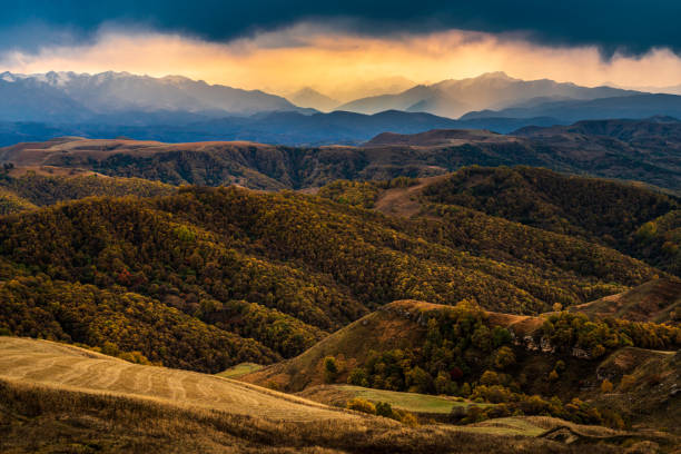 Great sunset with a view on mountain ridge and valley from Gumbashi mountain pass, Elbrus region, Russia