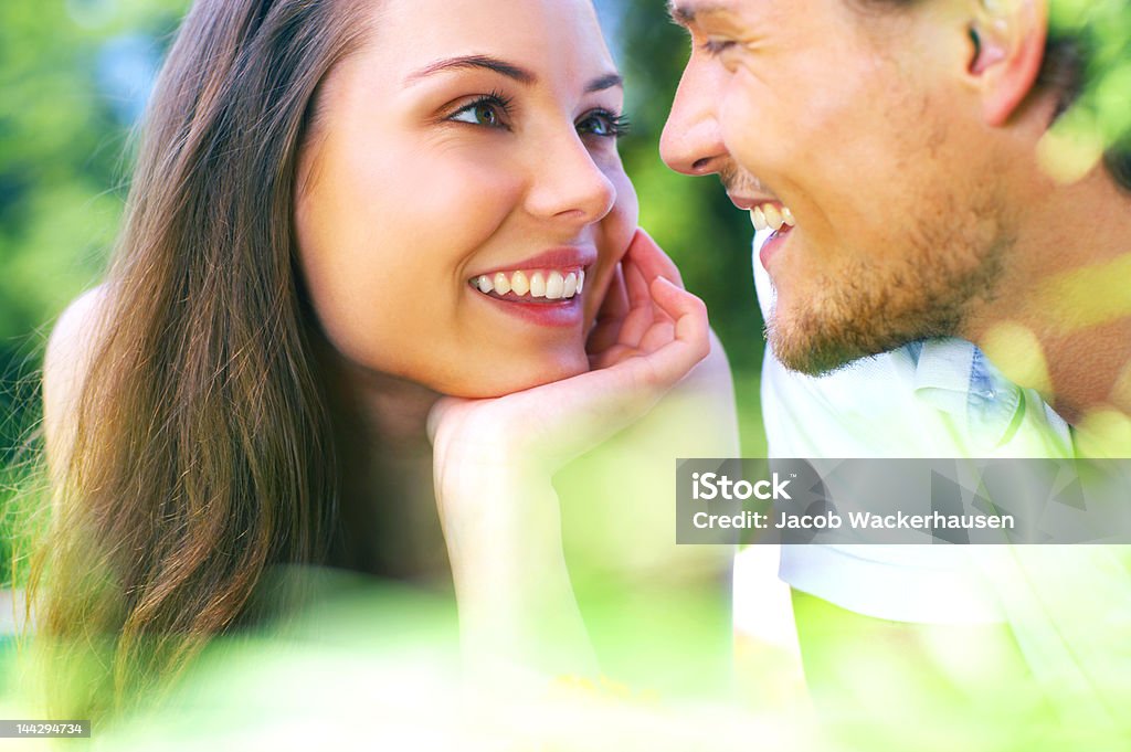 Attractive young couple gazing into each others eyes Attractive young couple gazing into each others eyes. Adult Stock Photo