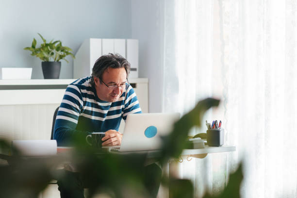 istock Businessman Drinking Coffee While Working At Home Office 1442952795