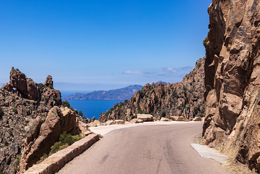 road through the Calanques de Piana, located in Piana, between Ajaccio and Calvi. It is part of a UNESCO World Heritage Site. The jagged cliffs are made of red ocher.