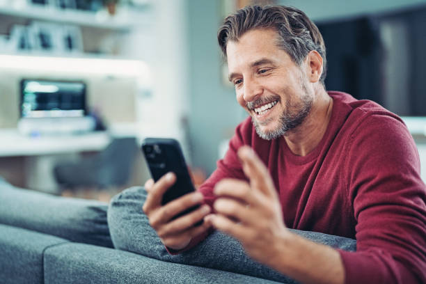 Smiling man having a video call stock photo