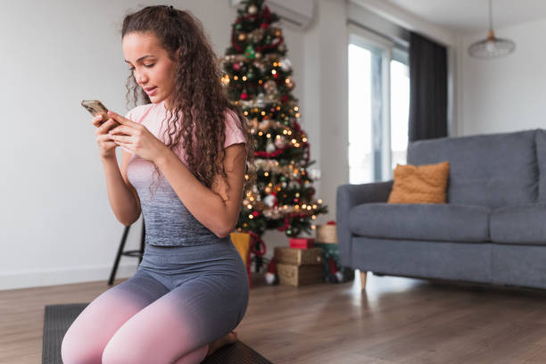 istock Fit woman using mobile phone, close-up 1442960171