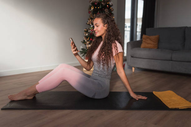 Fit woman using smart phone when finishing workout