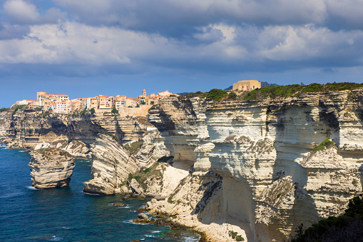 fortified town of Bonifacio high on the chalk cliffs on a sunny summer day; Bonifacio, France