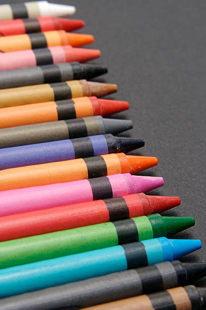 Colorful crayons against black stock photo