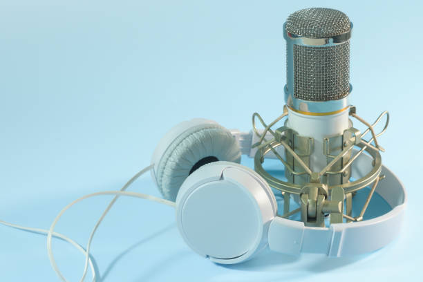 istock White headphones and microphone. For sound recording. on a blue background. copy space 1442971771