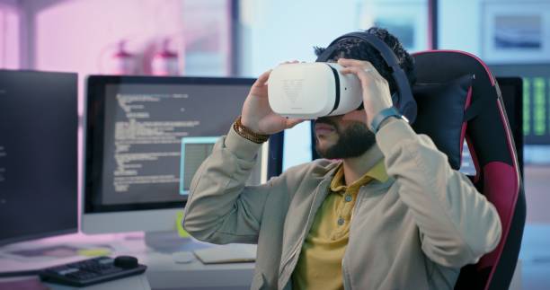 istock Future, programming and man with virtual reality headset in futuristic neon office with computer. Software, web design and vr, tech programmer or ux designer coding creative metaverse game project. 1442973916