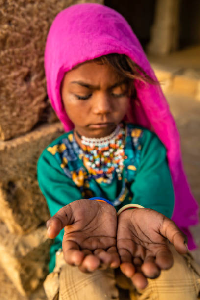 istock Poor Indian girl asking for help 1442975240