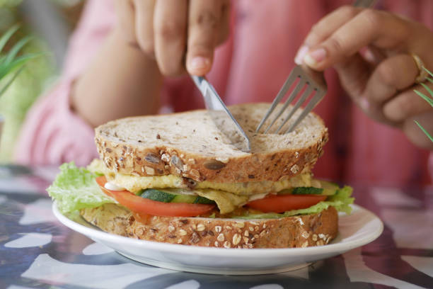 istock egg sandwich made with brown bread, tomato and lettuce on table 1442975452