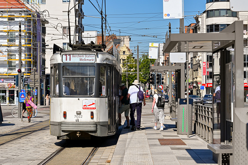 Antwerp, Belgium - August 2022: People catching a tram in the city centre