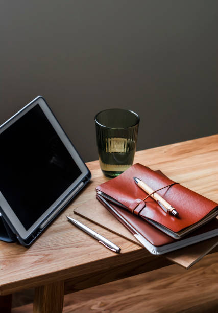 istock Accessories for education, work - notebooks, tablets, stationery on a wooden table 1442979962