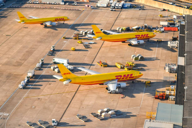 aerial view of cargo planes operated by dhl at an airport freight terminal - dhl airplane freight transportation boeing imagens e fotografias de stock