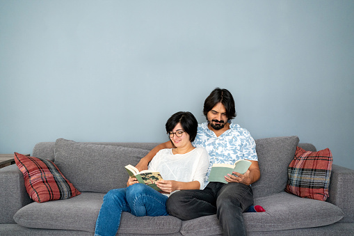 Couple in love  reading book on the sofa