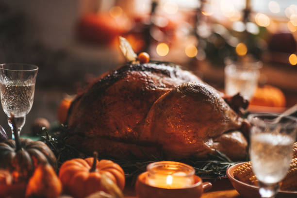 istock Thanksgiving holiday dinner table setting with fall decoration and pumpkins 1442980442