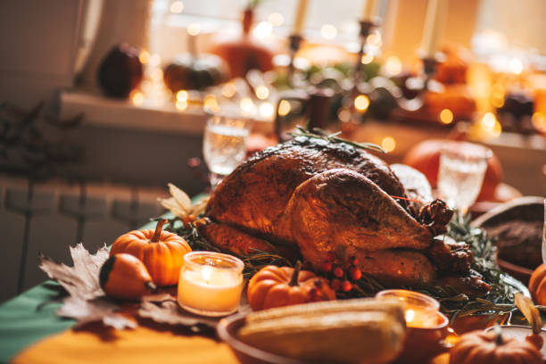 istock Thanksgiving holiday dinner table setting with fall decoration and pumpkins 1442980457