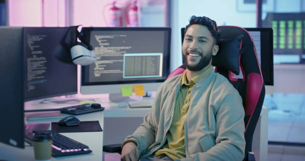 istock UX design, future and portrait of programmer at desk in neon office, man working on software development project on computer. Web, happy network developer from India coding and programming for vr app 1442980562
