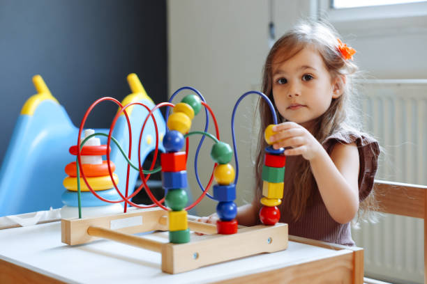 istock Portrait cute preschool age boy playing with bead puzzle 1442980602