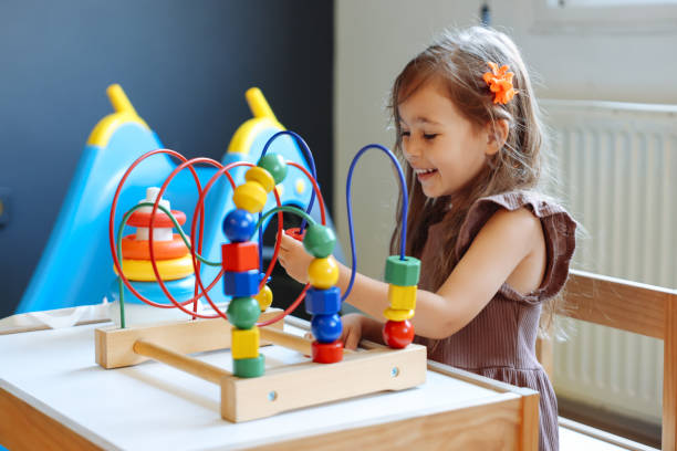istock Portrait cute preschool age boy playing with bead puzzle 1442980637
