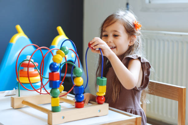 istock Portrait cute preschool age boy playing with bead puzzle 1442980751