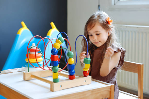 istock Portrait cute preschool age boy playing with bead puzzle 1442981336