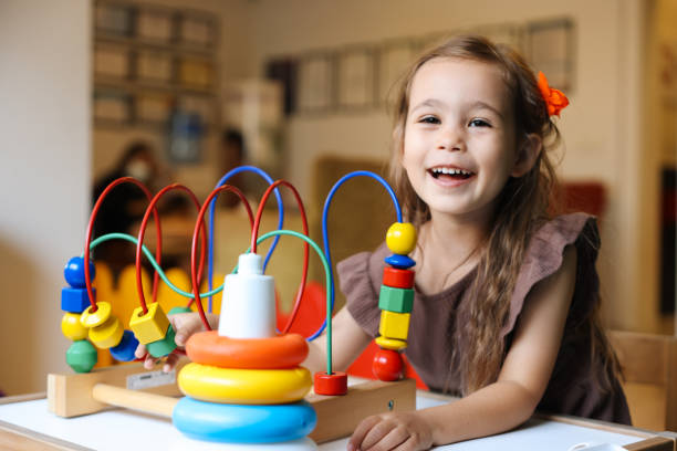 istock Portrait cute preschool age boy playing with bead puzzle 1442981359