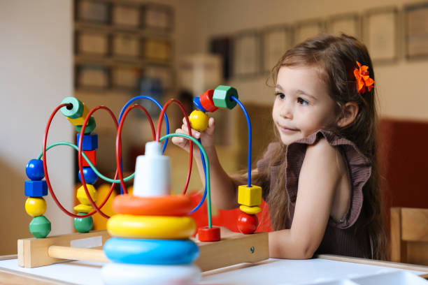 istock Portrait cute preschool age boy playing with bead puzzle 1442981407