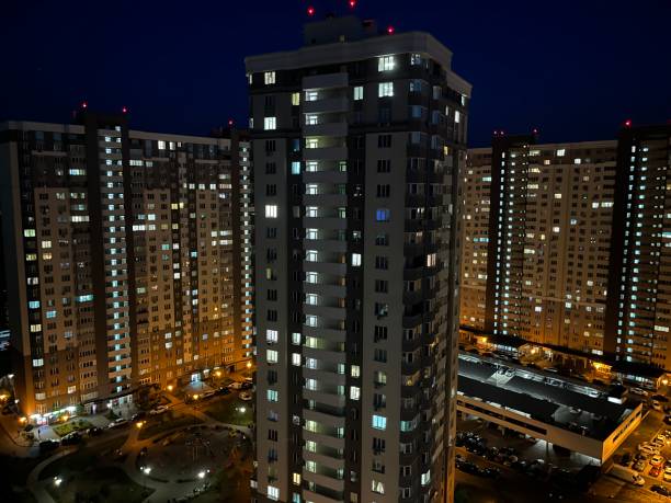 istock Evening city with buildings and light in the window 1442981433