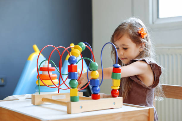 istock Portrait cute preschool age boy playing with bead puzzle 1442981437