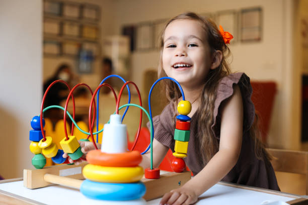istock Portrait cute preschool age boy playing with bead puzzle 1442981479
