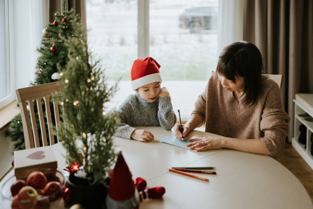 istock Mother and son writing a letter to Santa Clause 1442981799
