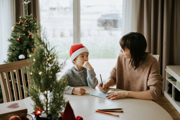 istock Mother and son writing a letter to Santa Clause 1442981802