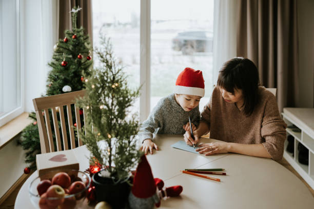 Mother and son writing a letter to Santa Clause
