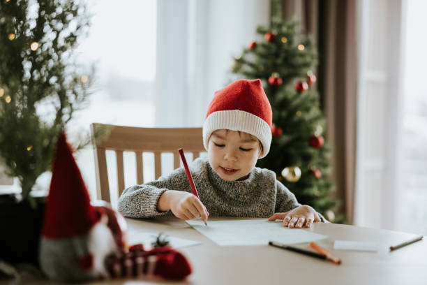 Boy writes a letter to Santa Clause stock photo