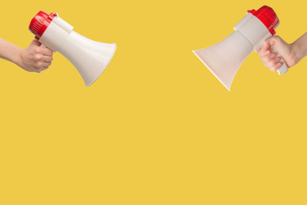 istock Megaphone in woman hands on a white background. 1442986912