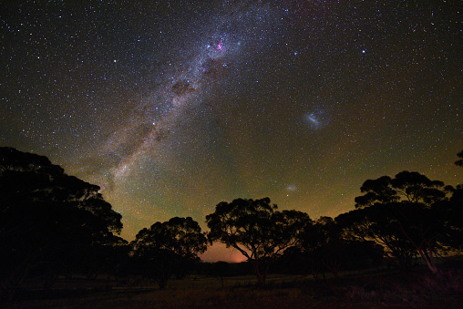 The Emu in the Night Sky, Southern Cross, Carina nebula and the Magellanic Clouds were taken from Youndegin two days before ANZAC Day. The orange-illuminated clouds which were caused by paddock burn-offs in Western Australia's Central Wheatbelt reminded me of the sun rays on the ANZAC Badge. The green from the airglow also continued through most of the night.