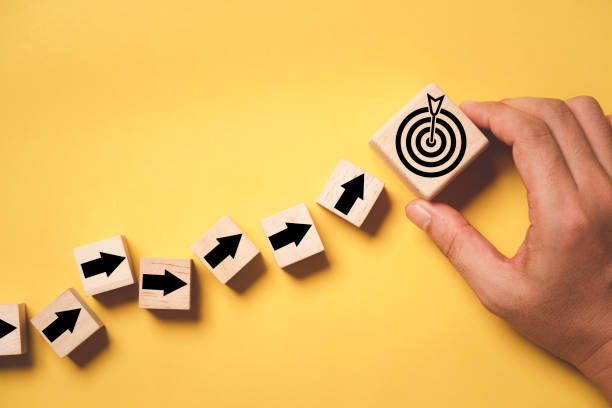 istock Hand putting virtual target board and arrow which print screen on wooden cube. Business achievement goal and objective target concept. 1442989055