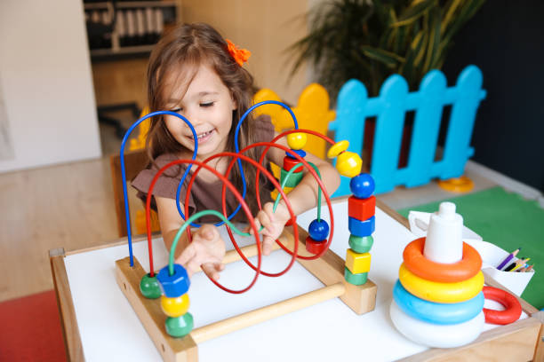 istock Portrait cute preschool age boy playing with bead puzzle 1442989348