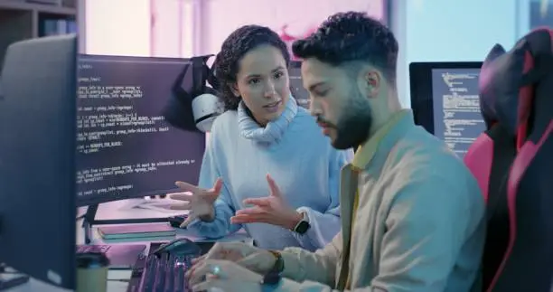 Photo of Computer, woman programmer and man training for coding, cyber security or software on computer. Female IT specialist, male coder or talking to connect internet, information update and cloud computing