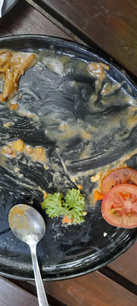 istock leftover on a black plate on a wooden table 1442991103