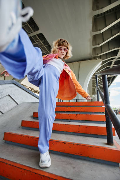 istock Young woman dancing in urban setting 1442992363
