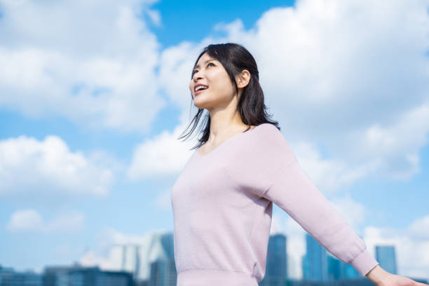 istock Young businesswoman taking a deep breath outside 1442994227