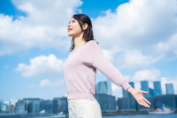 istock Young businesswoman taking a deep breath outside 1442994236