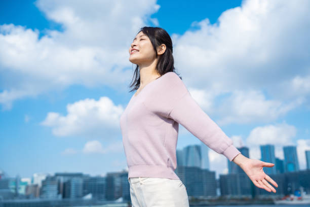 istock Young businesswoman taking a deep breath outside 1442994237
