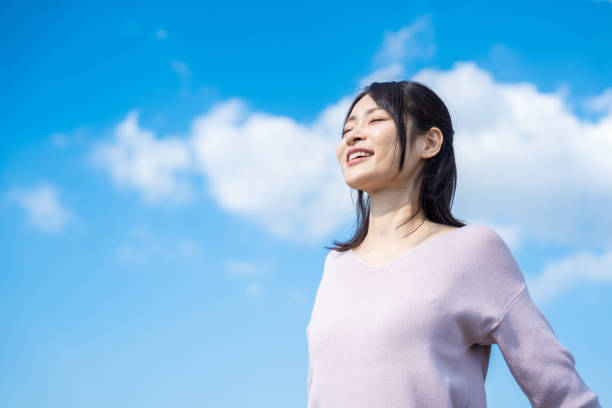 istock Young businesswoman taking a deep breath outside 1442994247