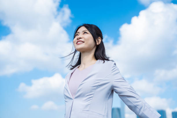 istock Young businesswoman taking a deep breath outside 1442994251