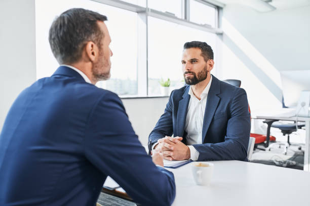 Negotiation of two businessmen in office. Job interview, business restructuring concept stock photo